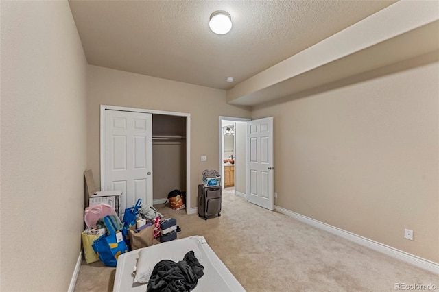 interior space with a textured ceiling and light colored carpet