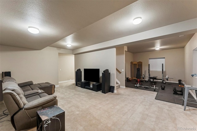 workout area with a textured ceiling and carpet