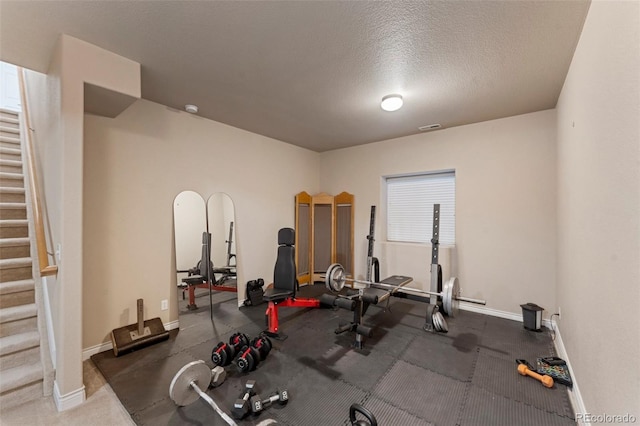 exercise room featuring a textured ceiling