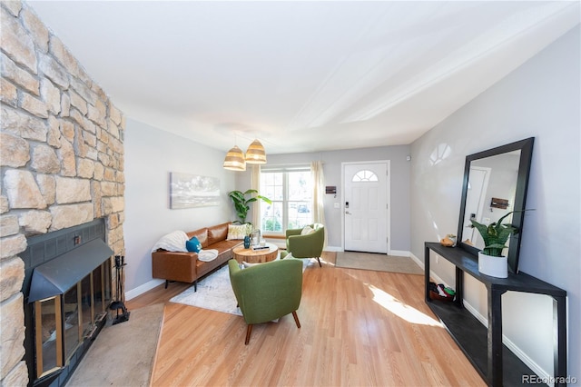 living room featuring wood-type flooring and a fireplace