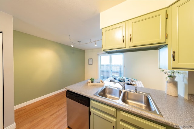 kitchen featuring dishwasher, sink, track lighting, and light wood-type flooring