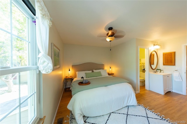 bedroom with ceiling fan, access to outside, light hardwood / wood-style flooring, and ensuite bathroom