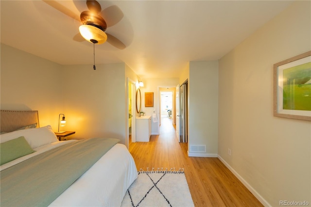 bedroom featuring ensuite bathroom, light wood-type flooring, and ceiling fan