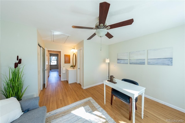 home office featuring light hardwood / wood-style flooring and ceiling fan