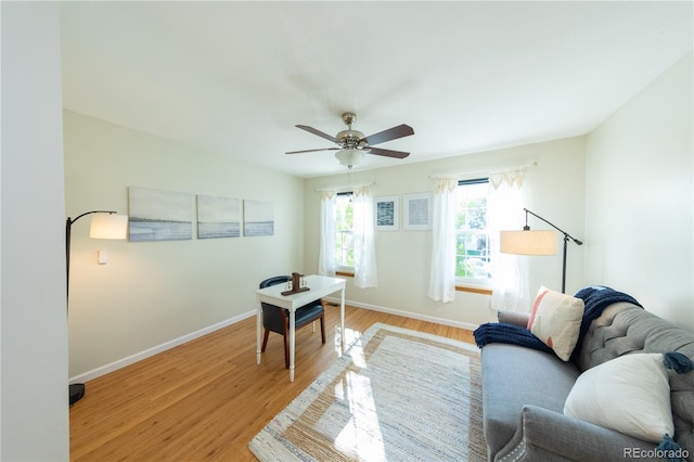 living room featuring ceiling fan and light wood-type flooring