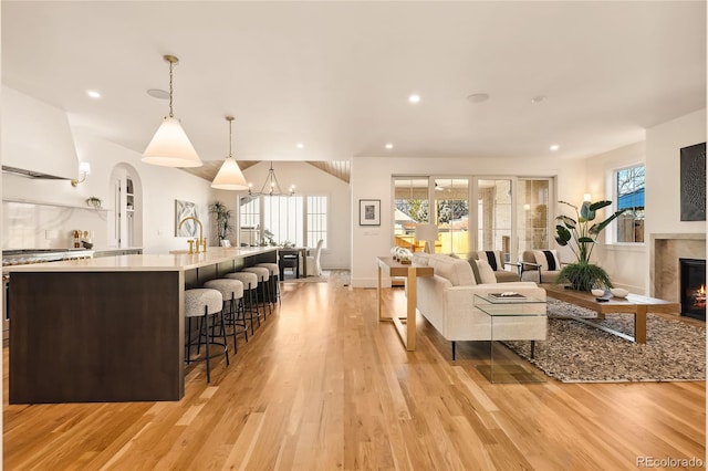 living room with light hardwood / wood-style floors and an inviting chandelier