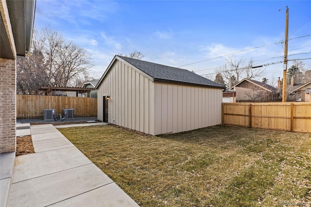 view of outbuilding featuring a yard and central AC