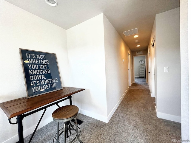 hallway with carpet floors