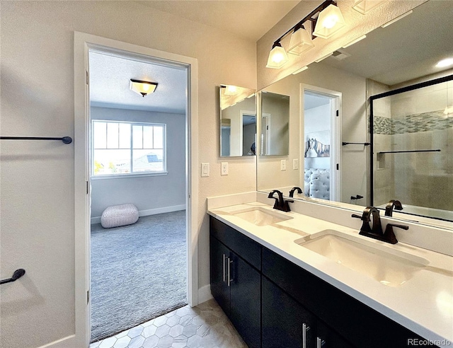 bathroom featuring vanity, a textured ceiling, tile patterned flooring, and a shower with door