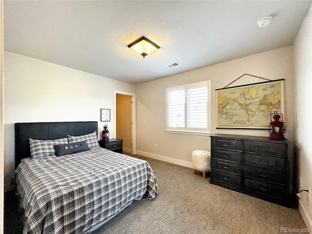 carpeted bedroom featuring a textured ceiling