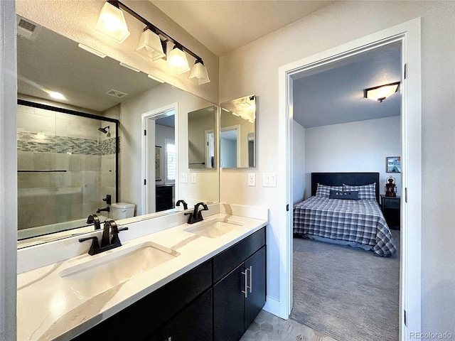 bathroom featuring a textured ceiling, vanity, toilet, and a shower with door