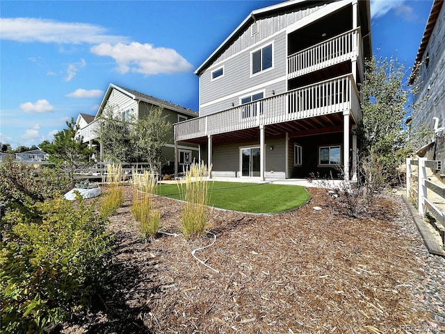 rear view of property with a lawn