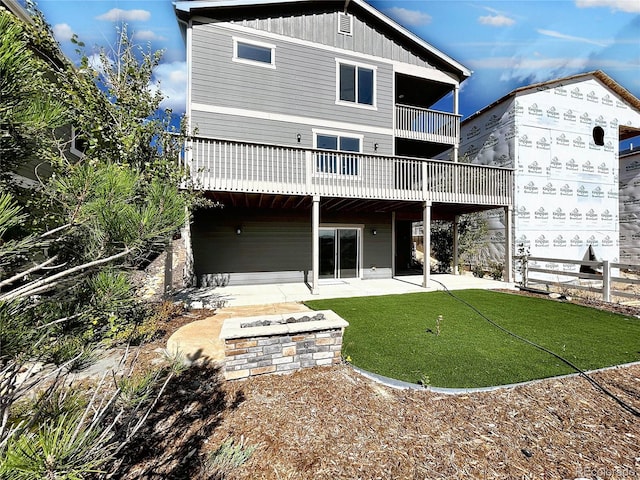 back of house with a lawn, a balcony, and a patio area