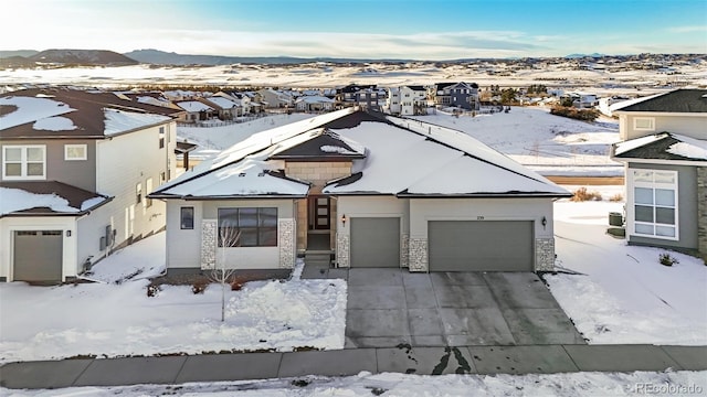 view of front facade with a garage and a mountain view