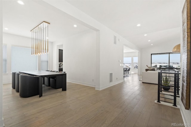 interior space featuring hardwood / wood-style flooring and lofted ceiling