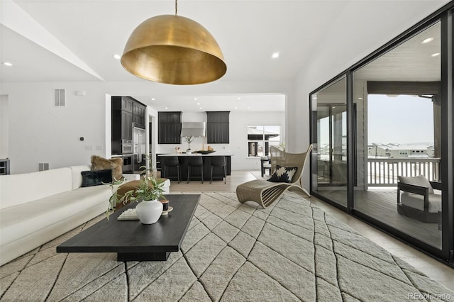 living room featuring lofted ceiling