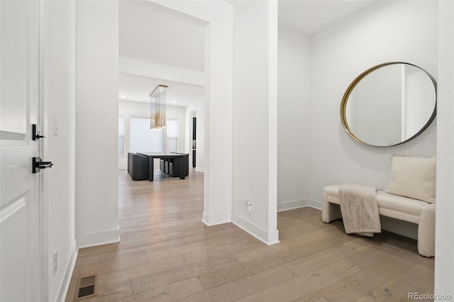 corridor with light hardwood / wood-style flooring