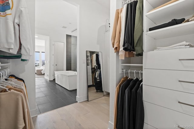 spacious closet featuring hardwood / wood-style flooring