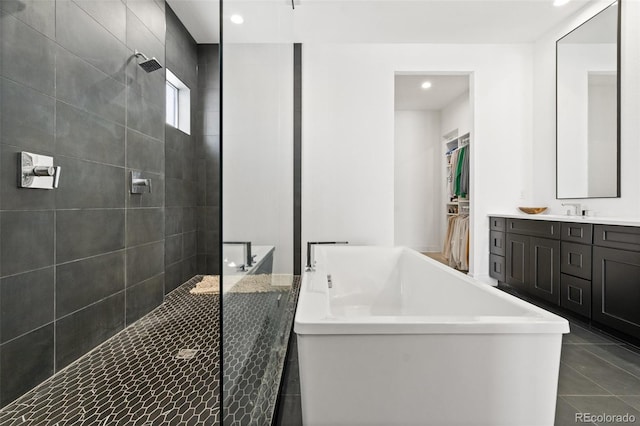 bathroom with vanity and separate shower and tub