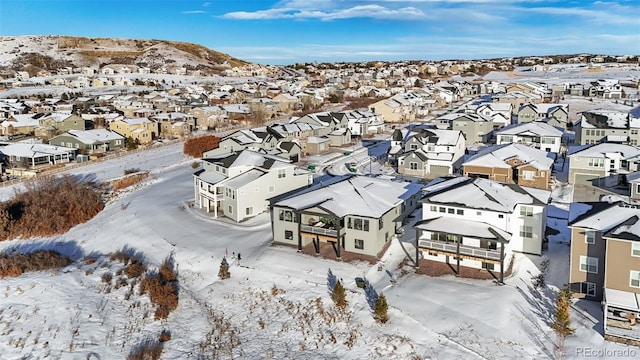 snowy aerial view featuring a mountain view