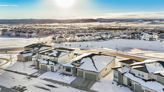 snowy aerial view featuring a mountain view