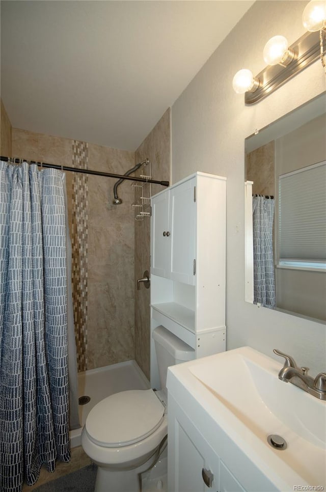 bathroom featuring vanity, toilet, and walk in shower