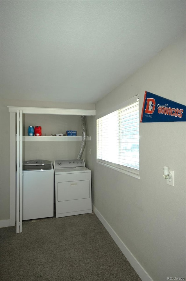 clothes washing area featuring separate washer and dryer and dark carpet