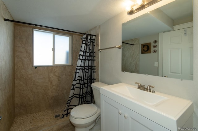 bathroom with a shower with curtain, vanity, and toilet