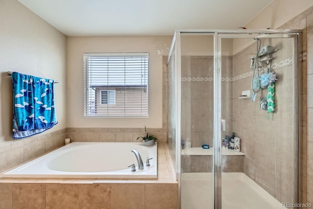 bathroom featuring independent shower and bath