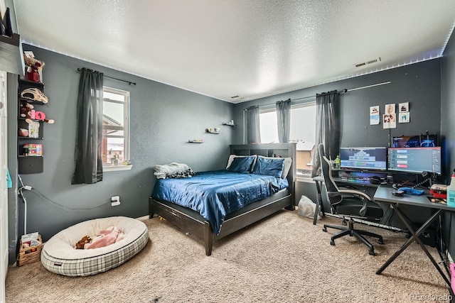 carpeted bedroom featuring a textured ceiling