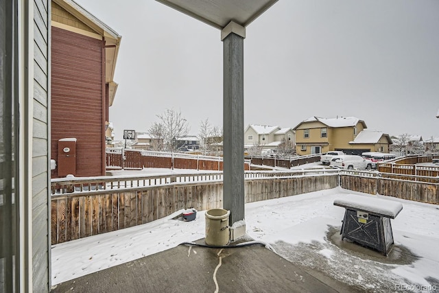 snow covered patio with an outdoor fire pit