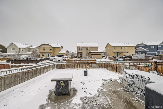 snow covered patio with a fire pit