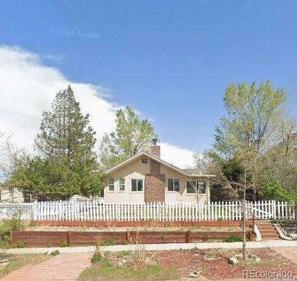 5040 Tennyson St, Denver, CO 80212 - view of front facade with a chimney and a fenced front yard