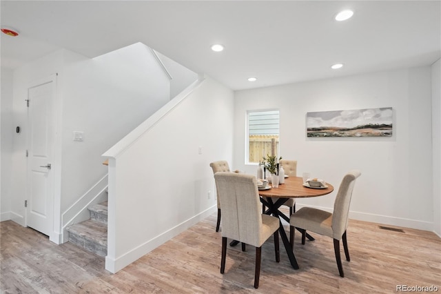 5242 Columbine Ln, Denver, CO 80221 - dining area featuring stairway, light wood-style floors, recessed lighting, and baseboards