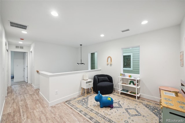 5242 Columbine Ln, Denver, CO 80221 - sitting room featuring wood finished floors, recessed lighting, baseboards, and an upstairs landing