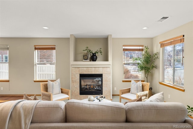 living room featuring a tile fireplace