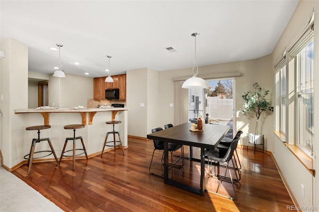 dining area with dark wood-type flooring