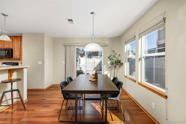 dining area with dark wood-type flooring