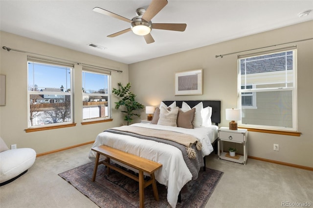 bedroom featuring light colored carpet and ceiling fan