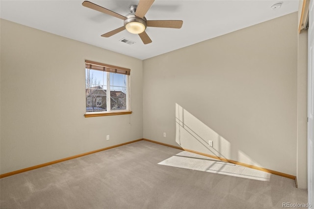 carpeted spare room with ceiling fan