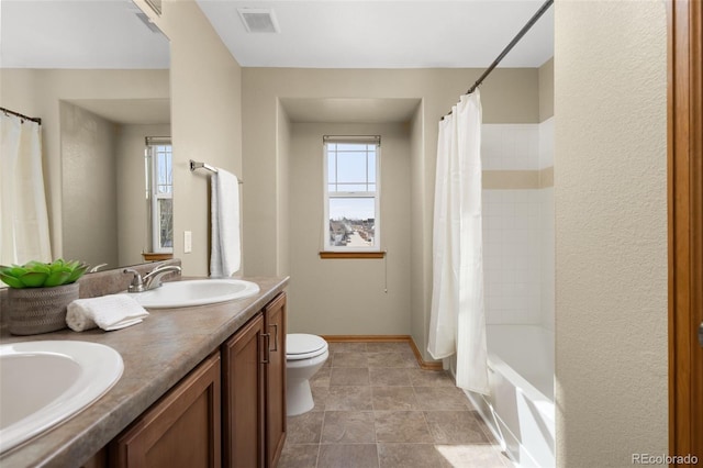 full bathroom featuring vanity, shower / bath combo, toilet, and a healthy amount of sunlight