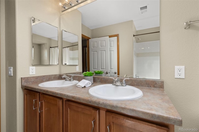 bathroom featuring vanity and curtained shower