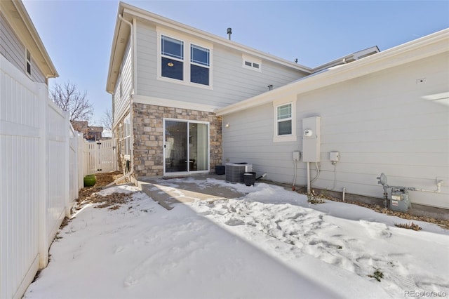 snow covered property featuring central air condition unit