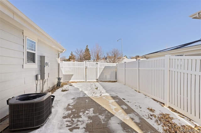 snow covered patio with central AC unit