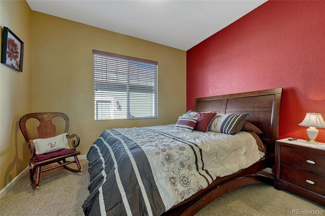 bedroom featuring baseboards and light colored carpet