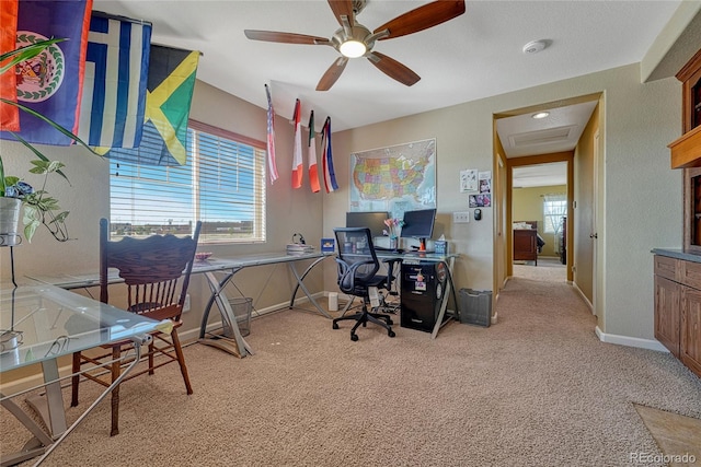 office area featuring baseboards, ceiling fan, and light colored carpet