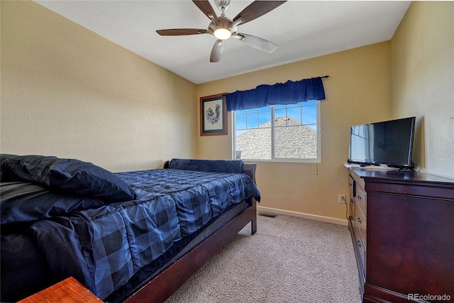 bedroom with baseboards, a ceiling fan, and light colored carpet