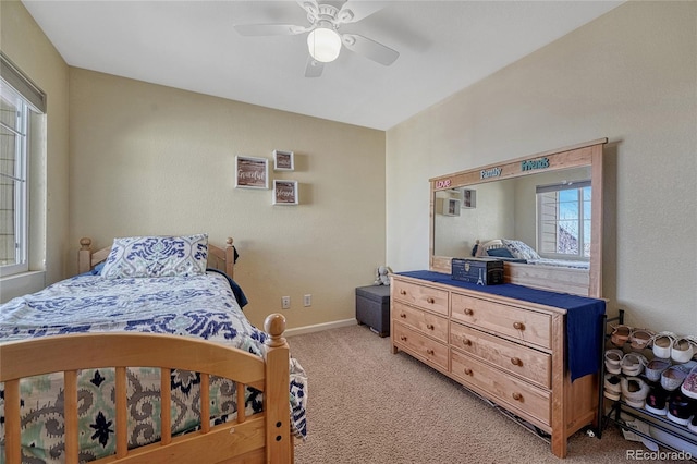 bedroom with light carpet, a ceiling fan, and baseboards