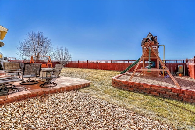 view of yard featuring a patio, a playground, and a fenced backyard