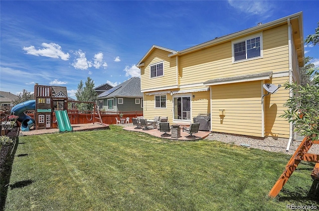 back of property featuring a yard, a playground, and a patio